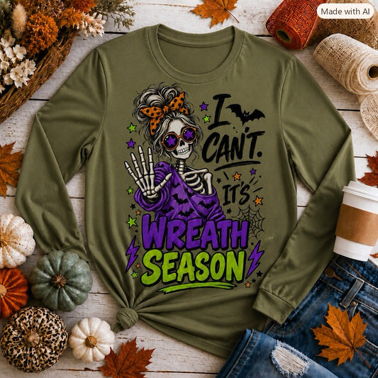 Close-up of funny fall skeleton tee reading "I Can't. It's Wreath Season" in purple and lime-green lettering