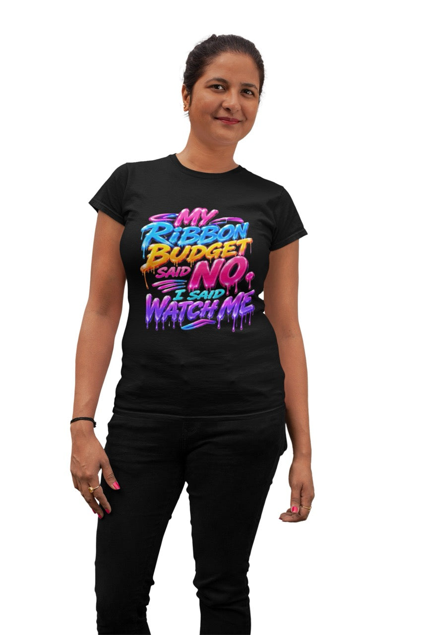 Graphic t-shirt featuring the phrase “My Ribbon Budget Said No, I Said Watch Me” in bold colorful lettering with a dripping paint effect, designed for wreath makers, crafters, and ribbon enthusiasts.