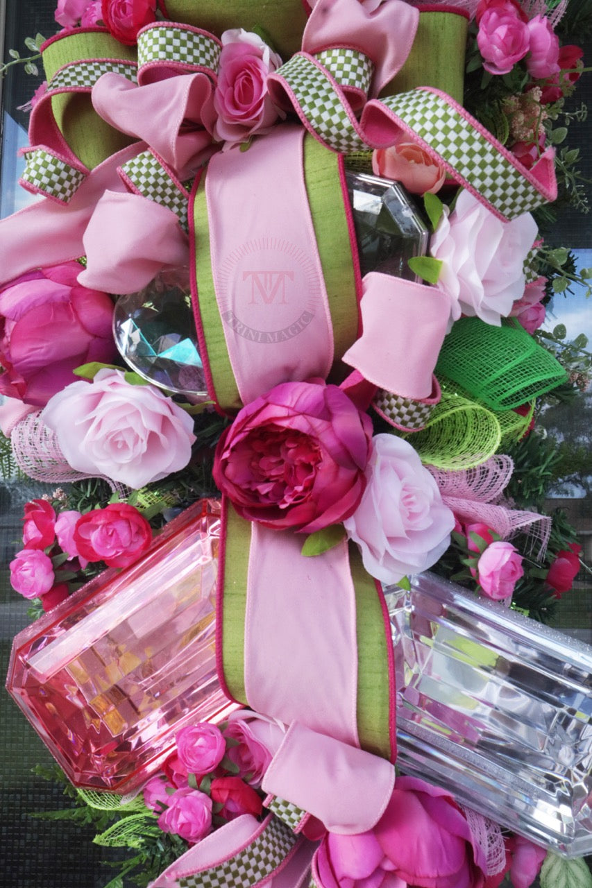 Pink floral gift box swag wreath with peonies, roses, green ribbon, and elegant front door decor