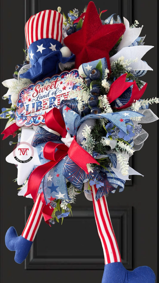 Sweet Land of Liberty patriotic swag wreath with Uncle Sam legs, red white blue ribbons, and star accents