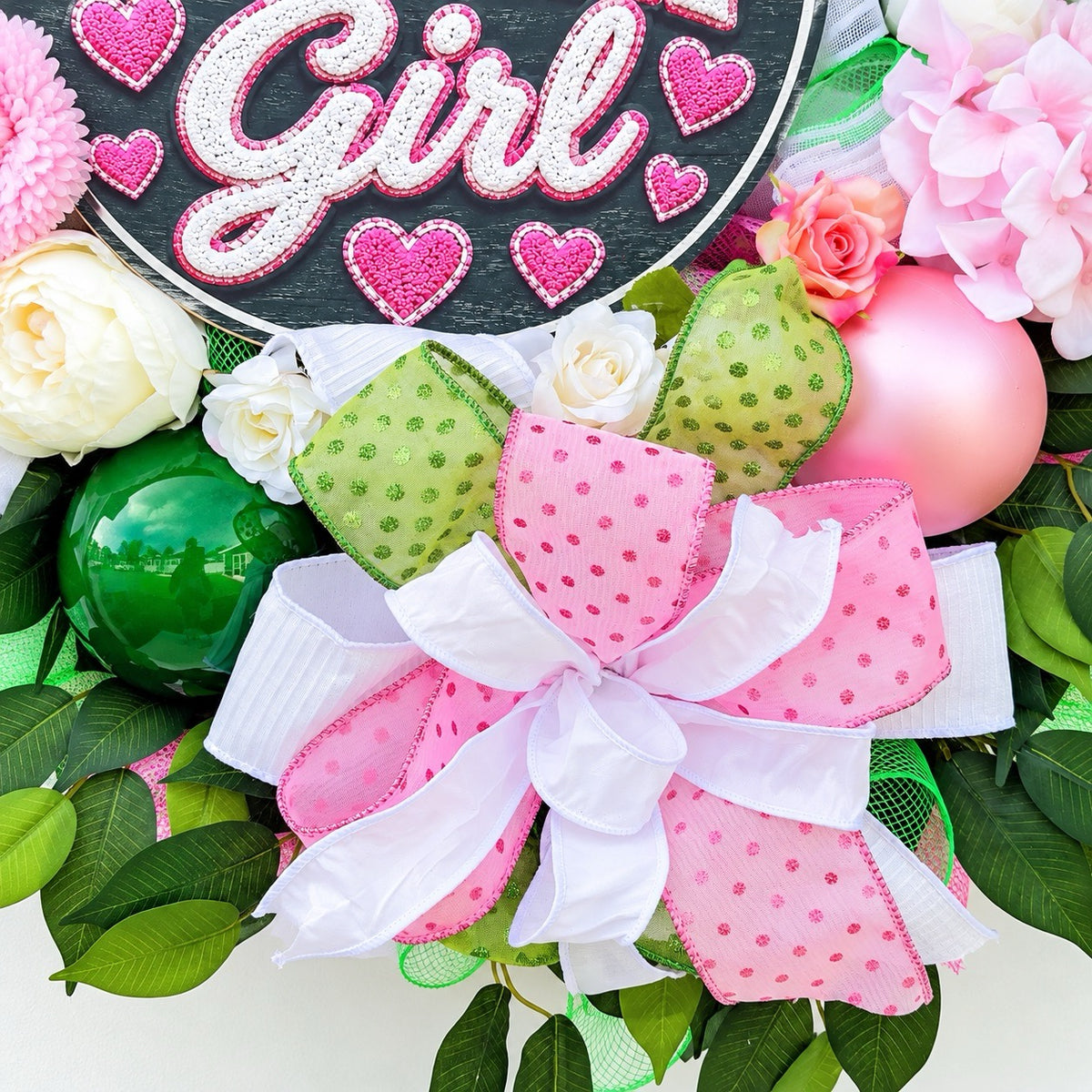 Close-up of layered pink polka-dot, lime-green, and white ribbon bow on handmade Philly Girl floral wreath.