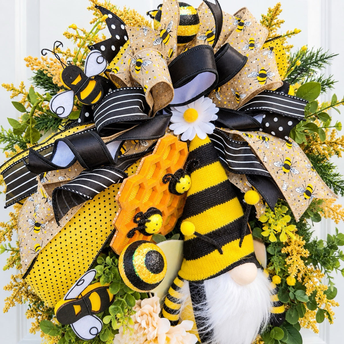 Handmade Queen Bee Manor wreath featuring a bee gnome, woven beehive, yellow and black designer bow, honeycomb accents, florals, bees, and lush greenery.