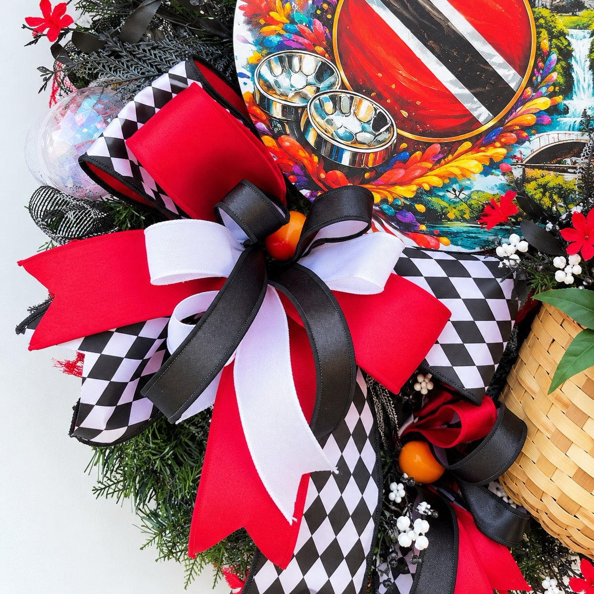 Close-up of layered red black and white decorative bows with black and white harlequin ribbon on a handmade Trinidad and Tobago wreath.