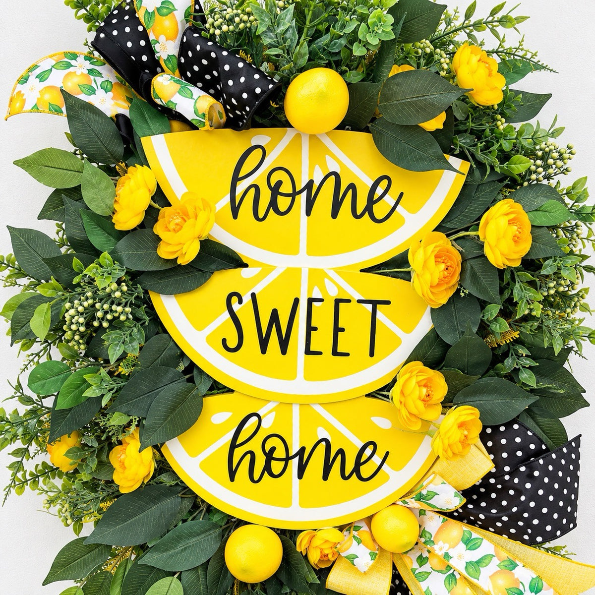 Handmade Lemon Sweet Home Summer Wreath featuring a yellow lemon-slice Home Sweet Home sign, bright yellow roses, decorative lemons, lush green foliage, and black-and-white polka-dot ribbon displayed on a white door.