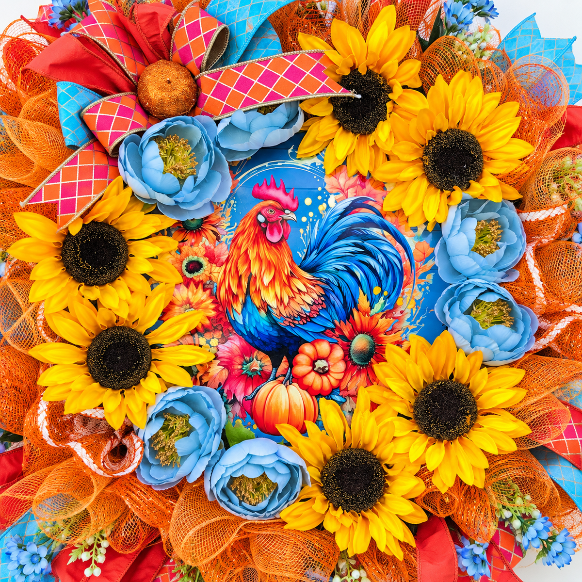Handmade fall rooster wreath featuring vibrant yellow sunflowers, dusty blue flowers, orange deco mesh, coral and turquoise ribbons, and a colorful rooster centerpiece. A full farmhouse-style autumn wreath displayed on a white front door.