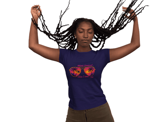 Person wearing a colorful Miami Carnival 2025 t-shirt featuring vibrant tropical artwork, flags, sunglasses, and festive Caribbean-inspired graphics.