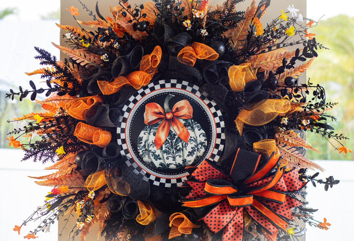 Luxury Halloween wreath with orange bow black mesh and fall foliage