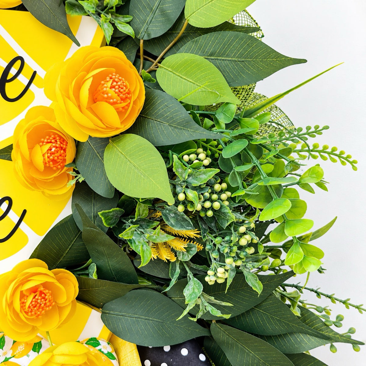 Handmade Lemon Sweet Home Summer Wreath featuring a yellow lemon-slice Home Sweet Home sign, bright yellow roses, decorative lemons, lush green foliage, and black-and-white polka-dot ribbon displayed on a white door.