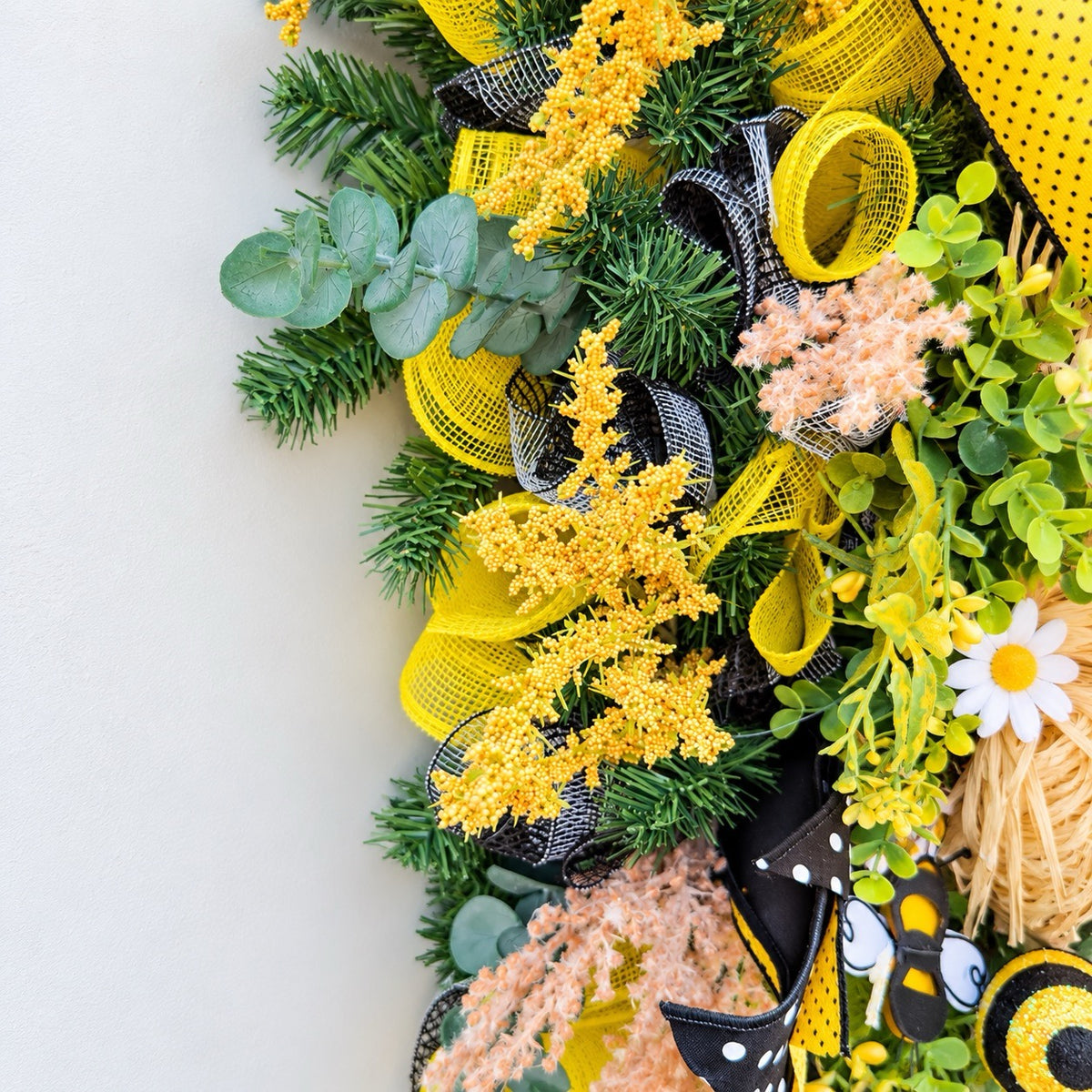 Handmade Queen Bee Manor wreath featuring a bee gnome, woven beehive, yellow and black designer bow, honeycomb accents, florals, bees, and lush greenery.