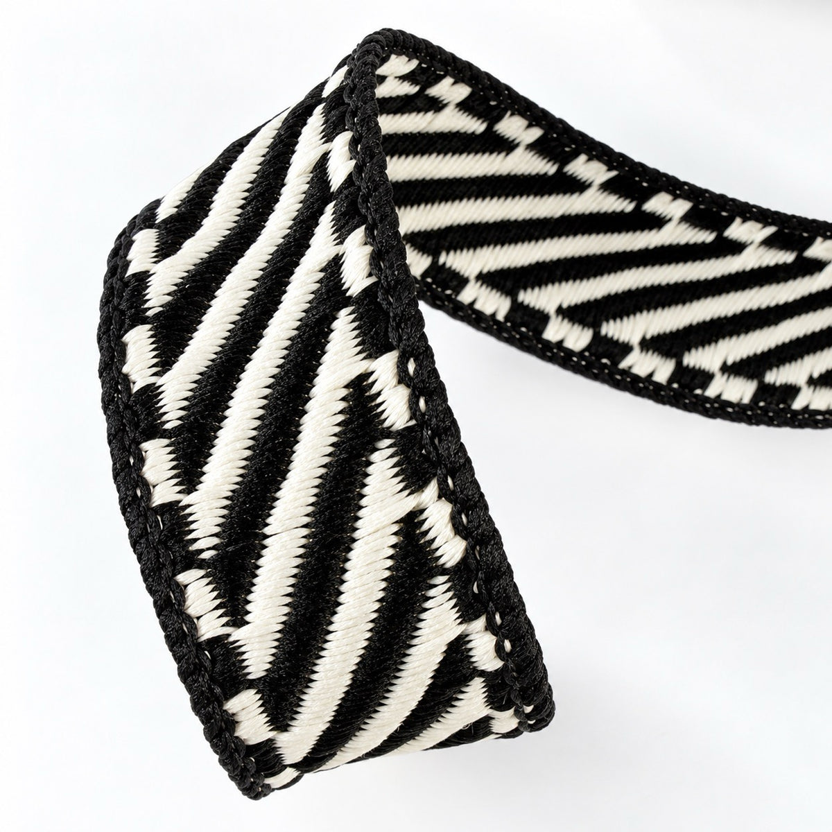 Farrisilk Shapeshifter black and white geometric wired ribbon, 1 inches wide, displayed on a full 10-yard spool with decorative ribbon loops.