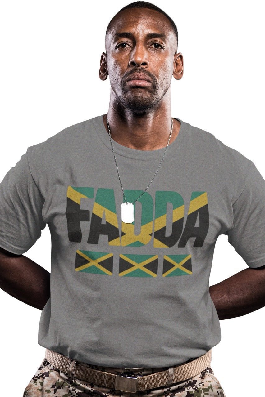 Man wearing a gray T-shirt with bold “FADA” text in Jamaican flag colors and three Jamaican flag icons underneath.