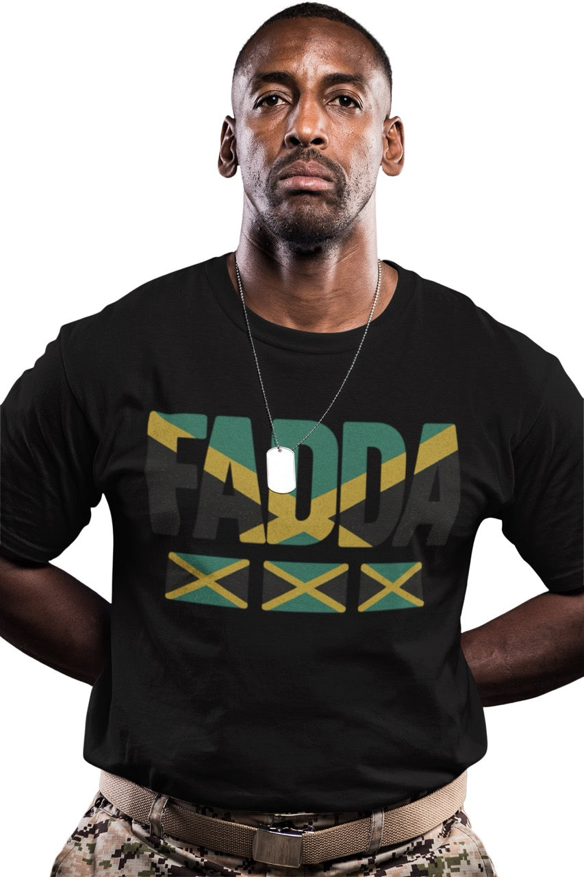 Man wearing a black T-shirt with bold “FADA” text in Jamaican flag colors and three Jamaican flag icons underneath.