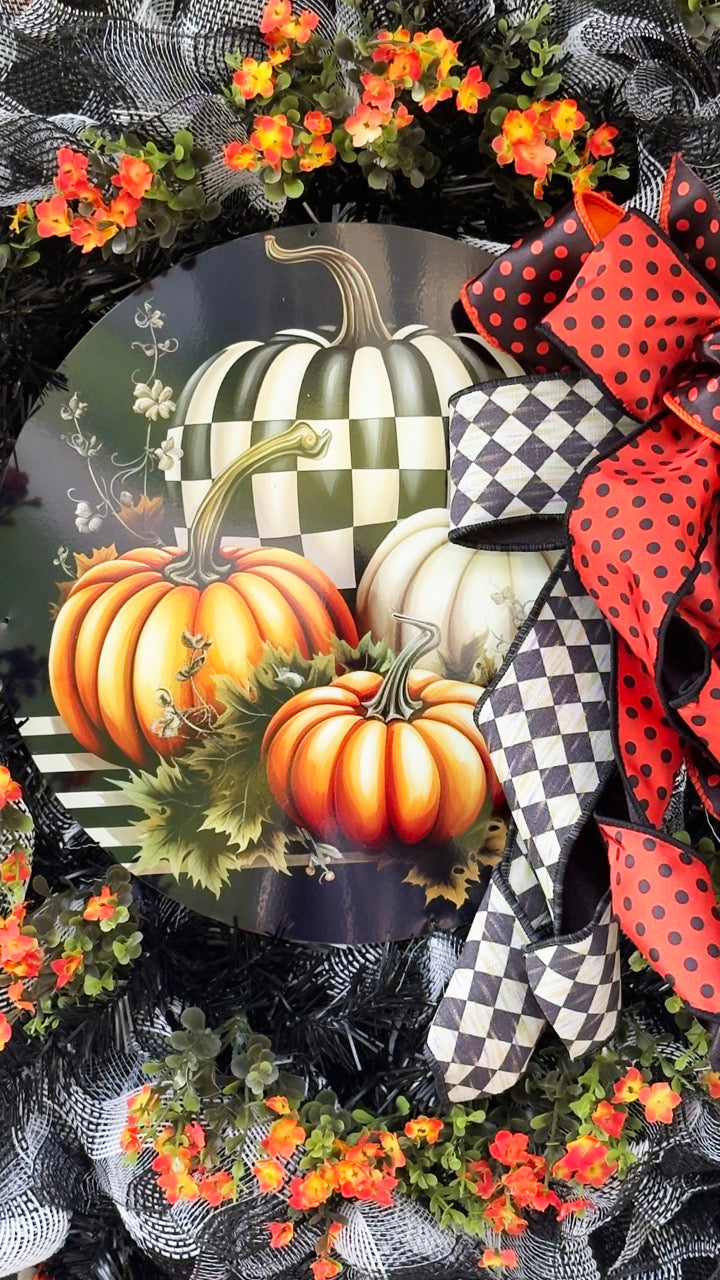 Harlequin Harvest Manor Wreath featuring lavender deco mesh, black florals, vibrant harlequin ribbon, sunflowers, and a whimsical purple pumpkin centerpiece displayed on a black front door.