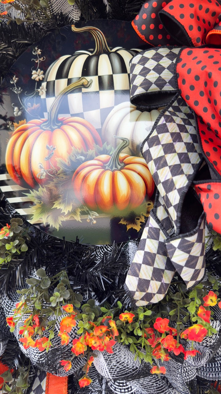 Harlequin Harvest Manor Wreath featuring lavender deco mesh, black florals, vibrant harlequin ribbon, sunflowers, and a whimsical purple pumpkin centerpiece displayed on a black front door.