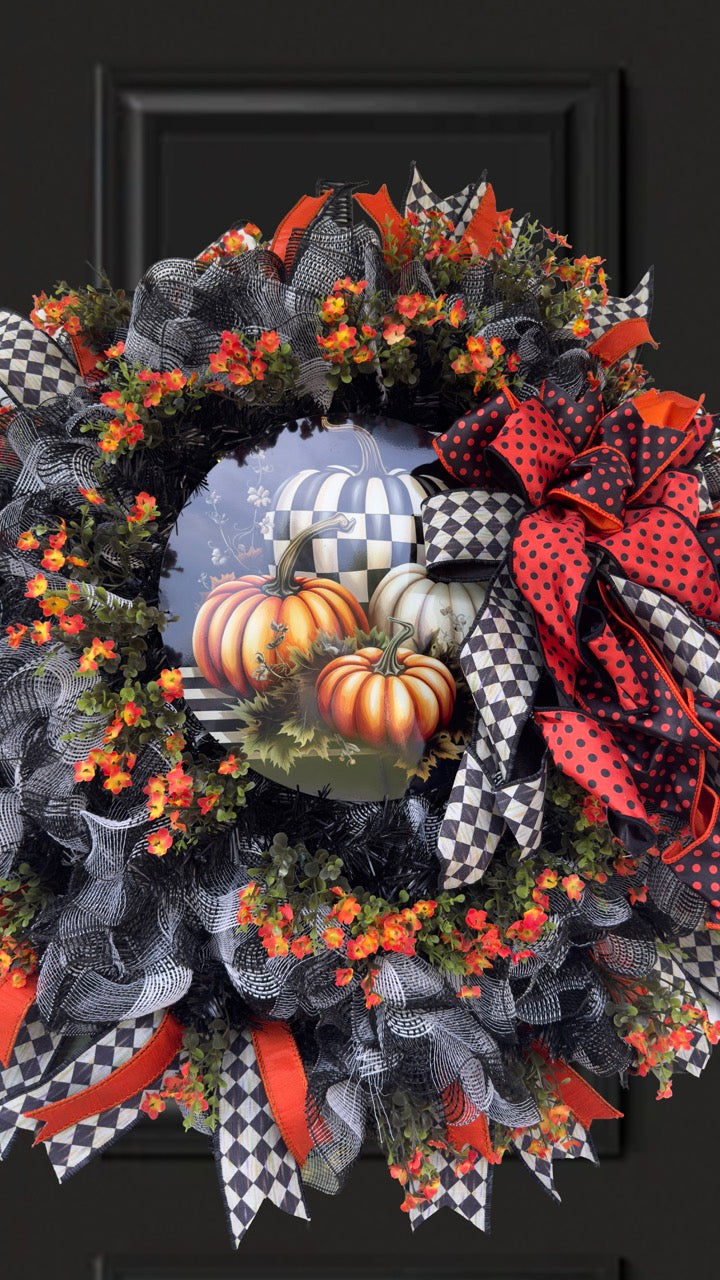 Harlequin Harvest Manor Wreath featuring lavender deco mesh, black florals, vibrant harlequin ribbon, sunflowers, and a whimsical purple pumpkin centerpiece displayed on a black front door.
