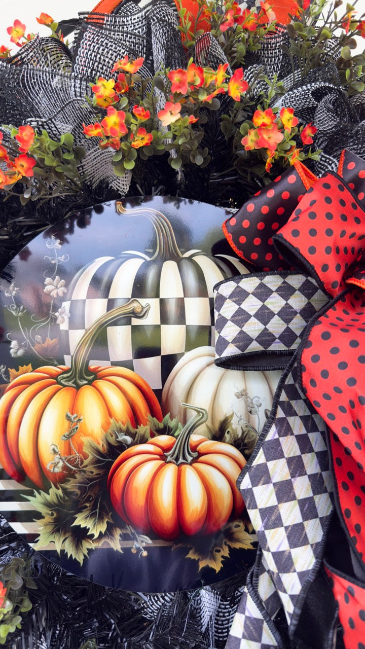 Harlequin Harvest Manor Wreath featuring lavender deco mesh, black florals, vibrant harlequin ribbon, sunflowers, and a whimsical purple pumpkin centerpiece displayed on a black front door.