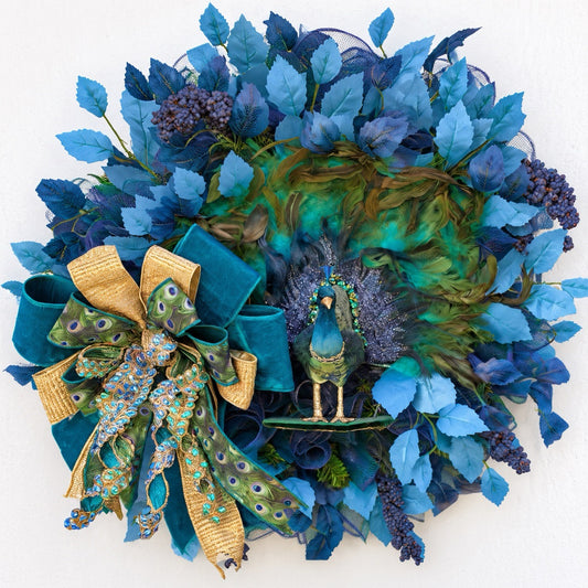Handmade luxury peacock wreath featuring vibrant turquoise feathers, blue foliage, and elegant ribbon accents.