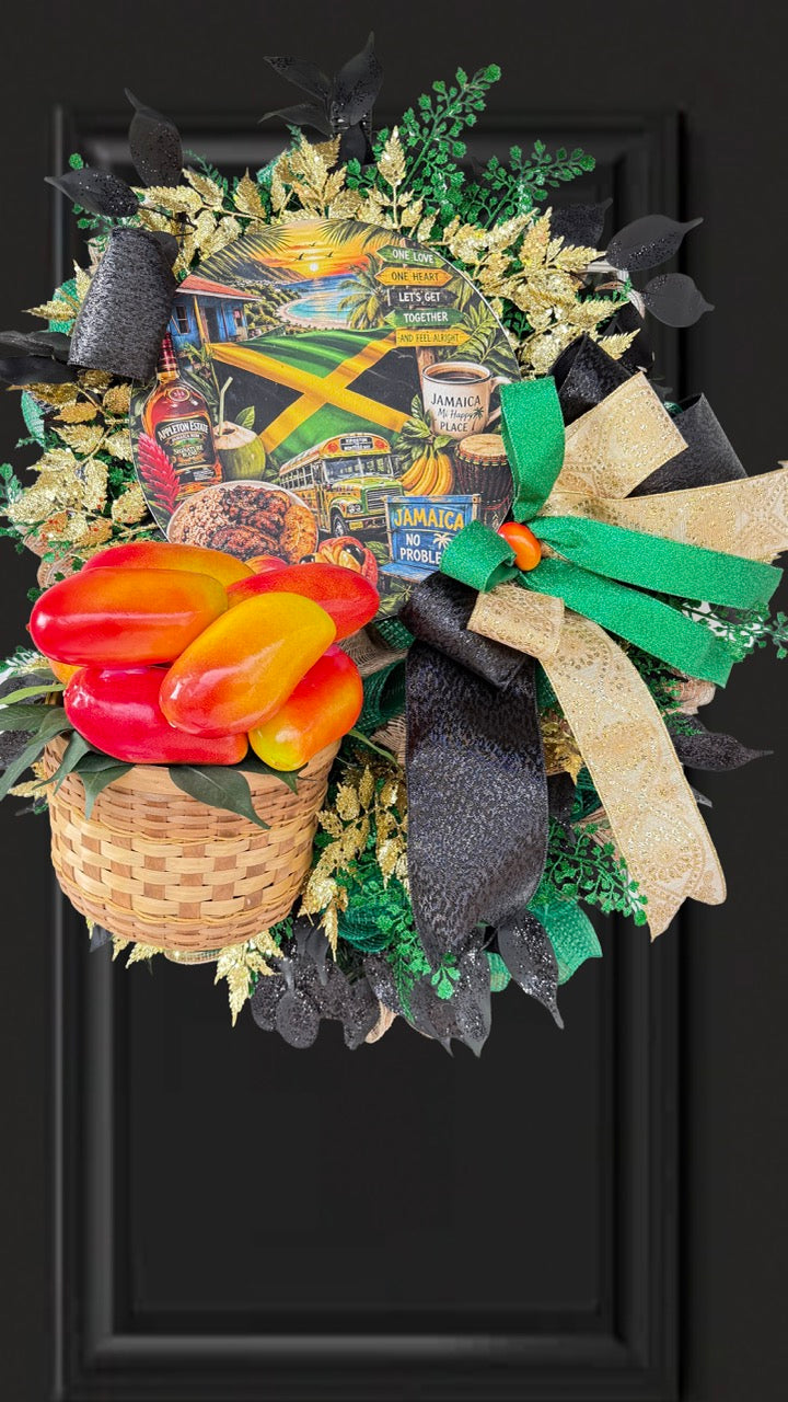 Luxury handmade Jamaica-inspired door wreath featuring green, black, and gold designer ribbons, tropical fruit basket, glittered foliage, and colorful island-themed artwork celebrating Jamaican culture and Caribbean décor.