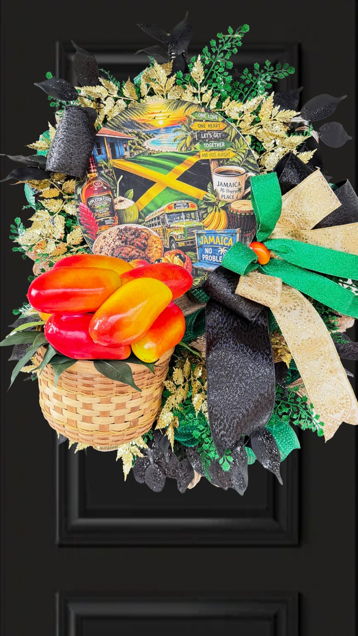 Luxury handmade Jamaica-inspired door wreath featuring green, black, and gold designer ribbons, tropical fruit basket, glittered foliage, and colorful island-themed artwork celebrating Jamaican culture and Caribbean décor.