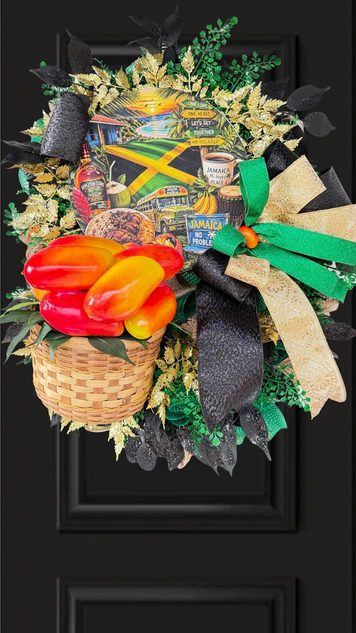 Luxury handmade Jamaica-inspired door wreath featuring green, black, and gold designer ribbons, tropical fruit basket, glittered foliage, and colorful island-themed artwork celebrating Jamaican culture and Caribbean décor.