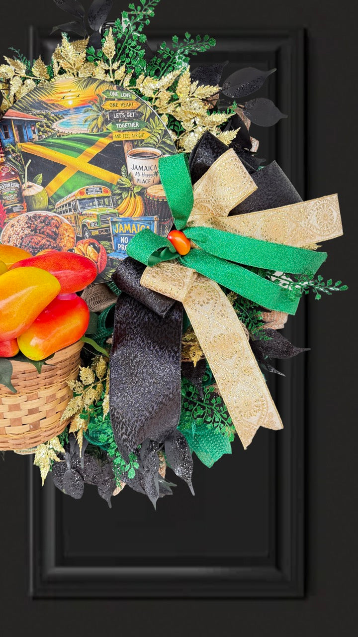 Luxury handmade Jamaica-inspired door wreath featuring green, black, and gold designer ribbons, tropical fruit basket, glittered foliage, and colorful island-themed artwork celebrating Jamaican culture and Caribbean décor.