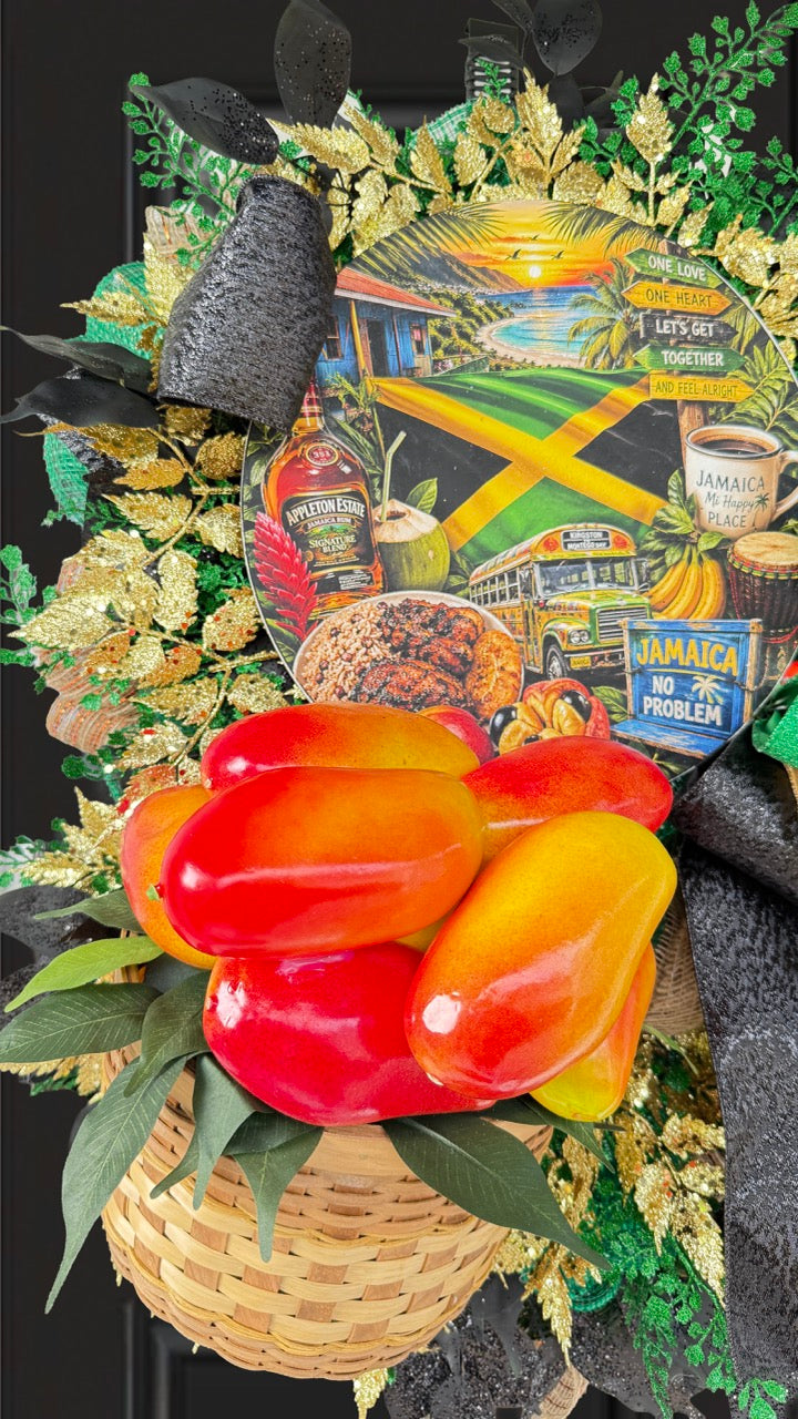Luxury handmade Jamaica-inspired door wreath featuring green, black, and gold designer ribbons, tropical fruit basket, glittered foliage, and colorful island-themed artwork celebrating Jamaican culture and Caribbean décor.