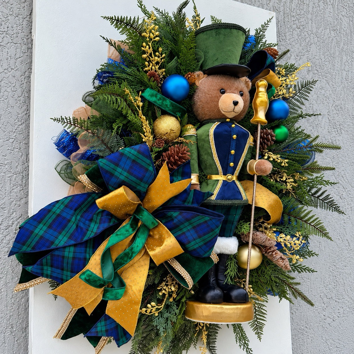 Side view showing the depth and layered greenery of the handmade Christmas wreath.