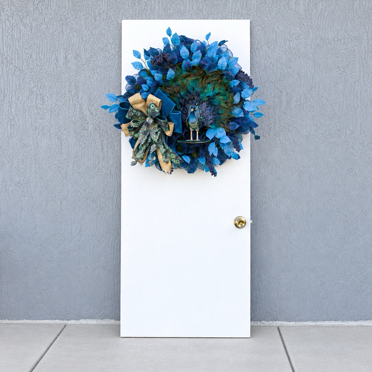Elegant handmade peacock wreath displayed on a white door, adding colorful statement decor to an entryway.