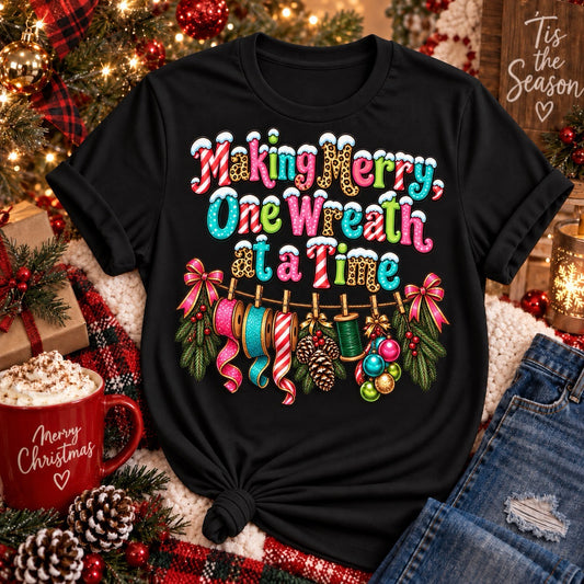 Making Merry One Wreath at a Time black Christmas wreath maker shirt with colorful ribbon and crafting design