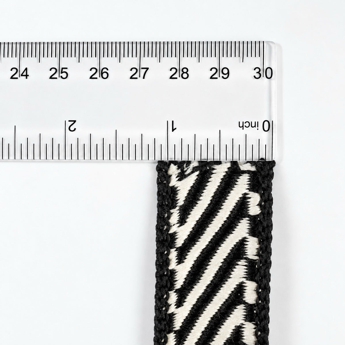 Farrisilk Shapeshifter black and white geometric wired ribbon, 1 inches wide, displayed on a full 10-yard spool with decorative ribbon loops.