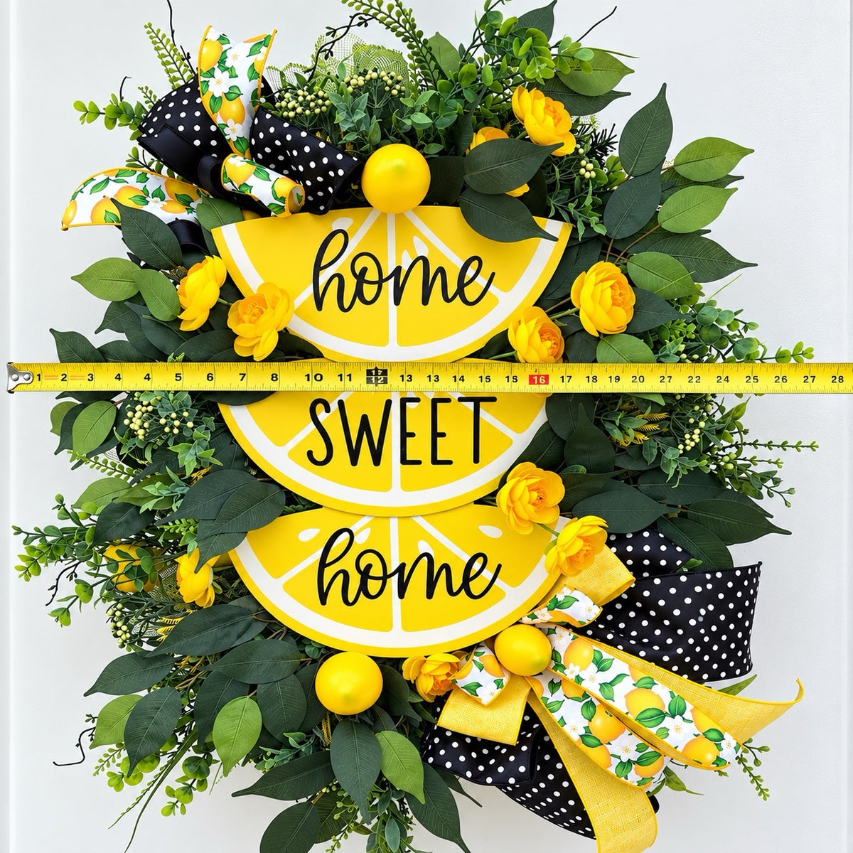 Handmade Lemon Sweet Home Summer Wreath featuring a yellow lemon-slice Home Sweet Home sign, bright yellow roses, decorative lemons, lush green foliage, and black-and-white polka-dot ribbon displayed on a white door.