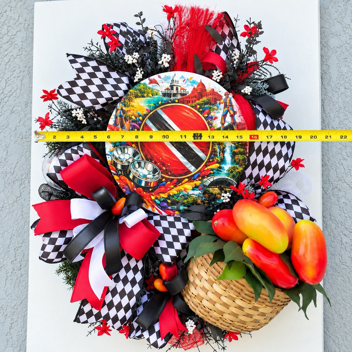 Handmade Trinidad and Tobago Caribbean front door wreath featuring a colorful Trinidad flag centerpiece, red black and white decorative bows, tropical greenery and woven basket filled with artificial peppers.
