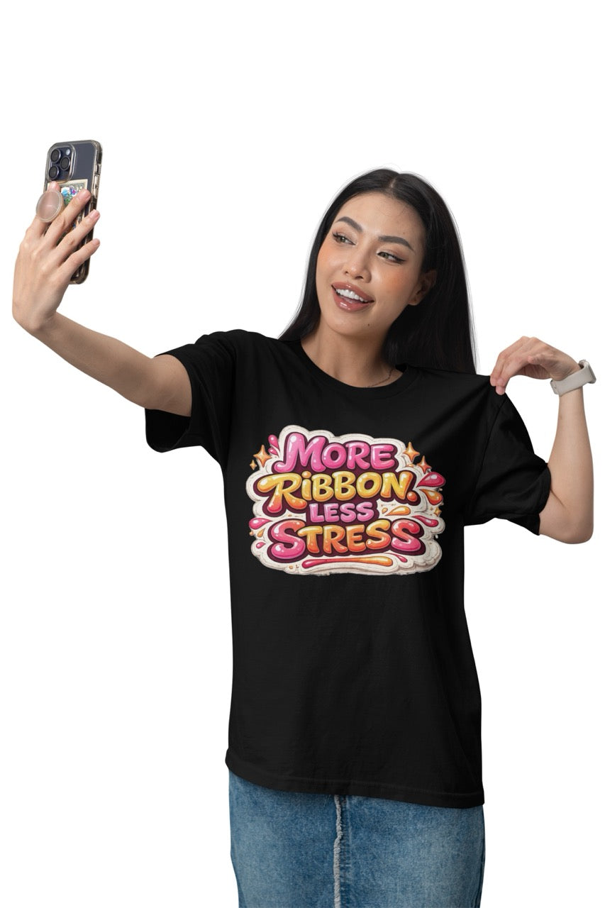 Unisex t-shirt featuring the phrase “More Ribbon. Less Stress.” in bold decorative lettering with playful craft-inspired accents, designed for wreath makers, crafters, and DIY enthusiasts.