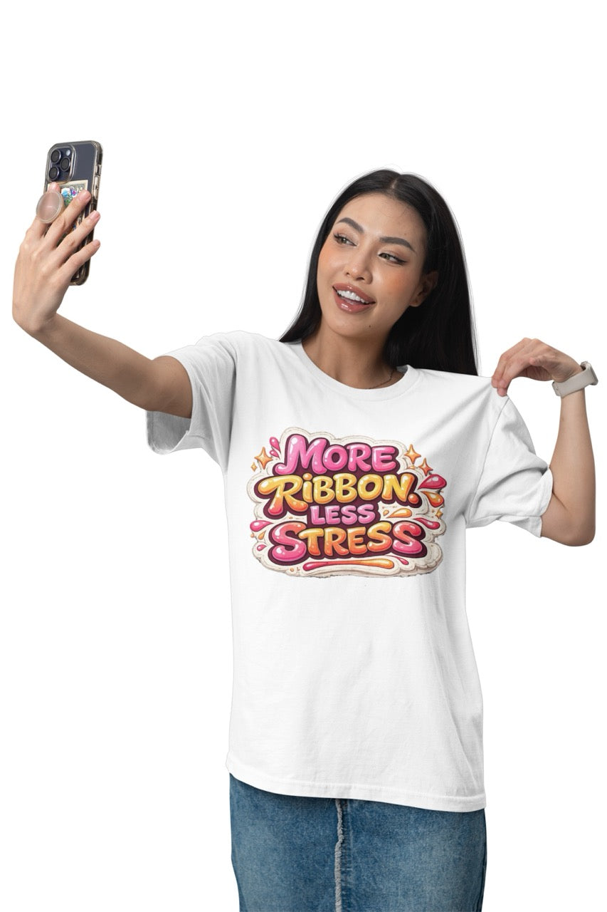 Unisex t-shirt featuring the phrase “More Ribbon. Less Stress.” in bold decorative lettering with playful craft-inspired accents, designed for wreath makers, crafters, and DIY enthusiasts.