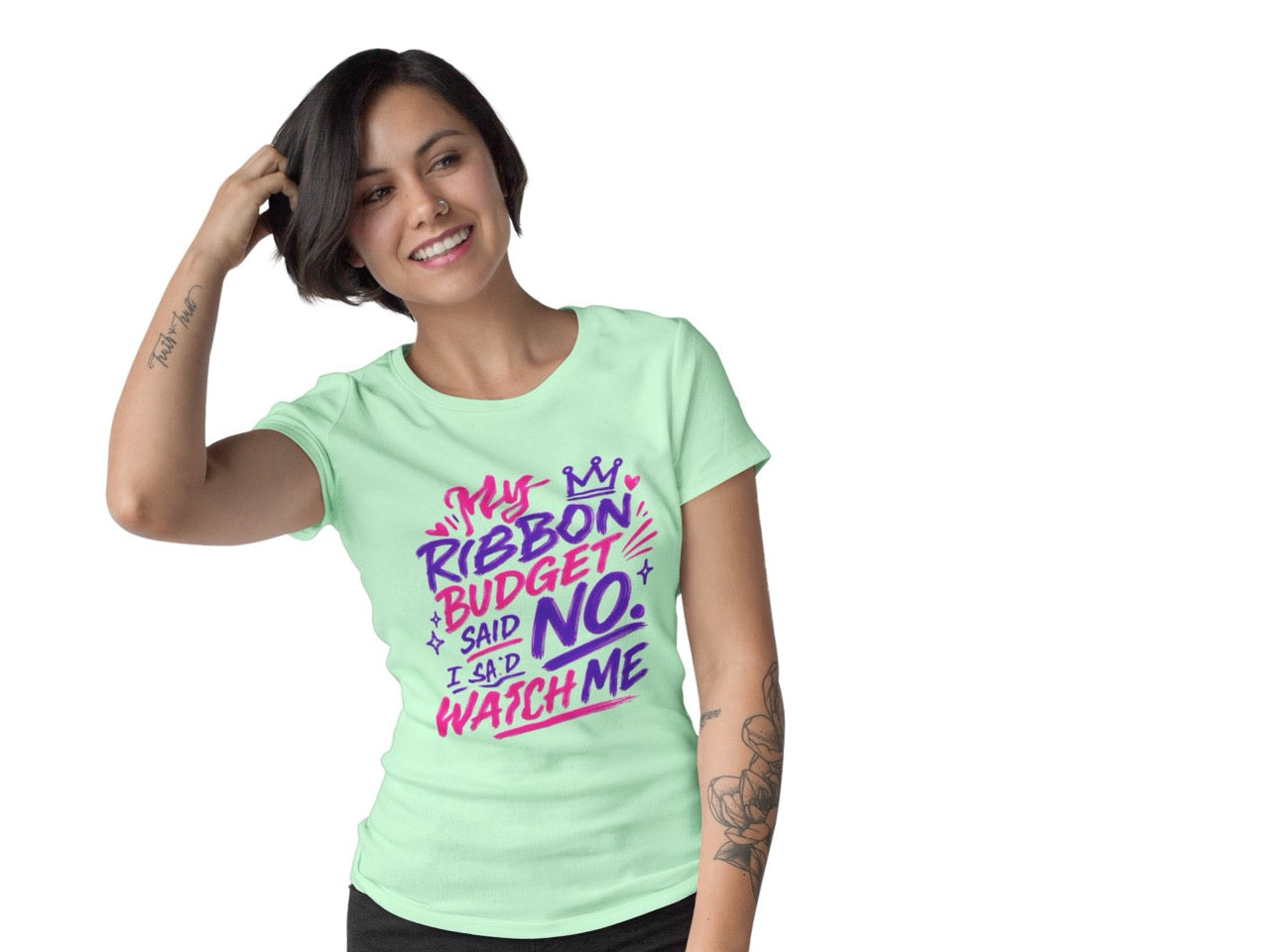 Woman wearing a t-shirt featuring the phrase “My Ribbon Budget Said No, I Said Watch Me” in bold, playful lettering designed for wreath makers, crafters, and ribbon enthusiasts.