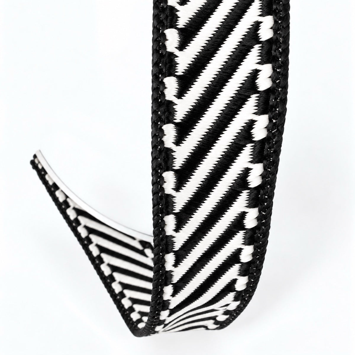 Farrisilk Shapeshifter black and white geometric wired ribbon, 1 inches wide, displayed on a full 10-yard spool with decorative ribbon loops.