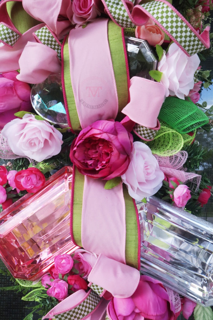 Pink floral gift box swag wreath with peonies, roses, green ribbon, and elegant front door decor