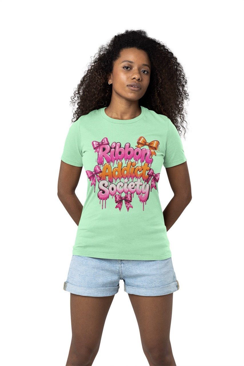 Ribbon Addict Society t-shirt featuring bold decorative lettering with bow accents and a fun crafting-themed graphic design for wreath makers and ribbon enthusiasts.