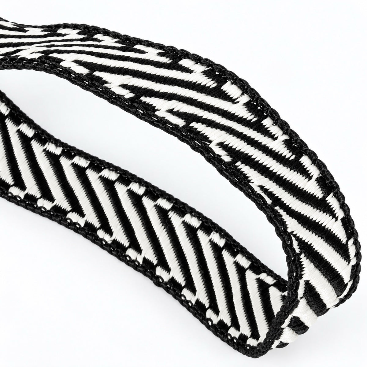 Farrisilk Shapeshifter black and white geometric wired ribbon, 1 inches wide, displayed on a full 10-yard spool with decorative ribbon loops.