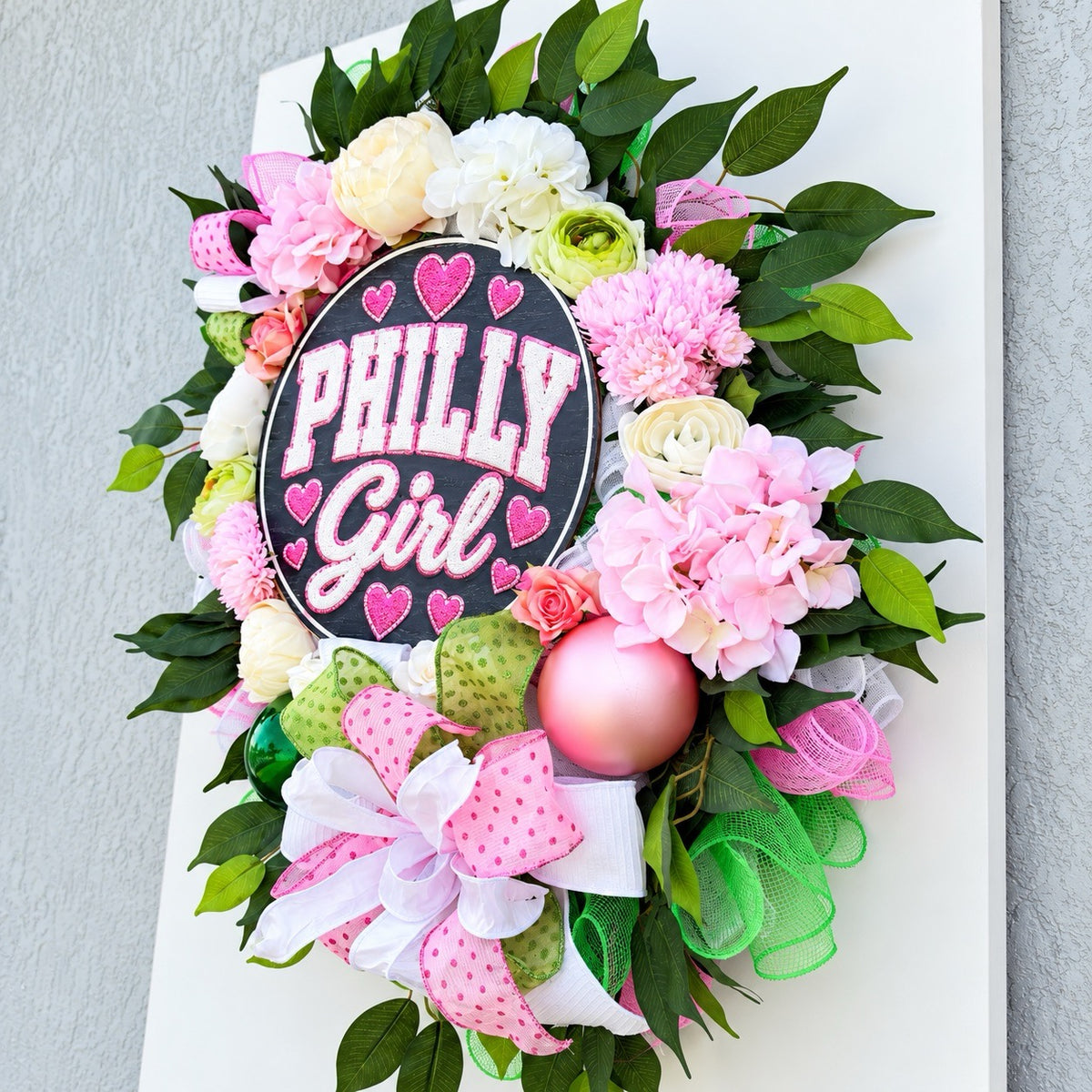 Right-angle view of Philly Girl floral wreath highlighting pink hydrangeas, green foliage, and dimensional floral accents.