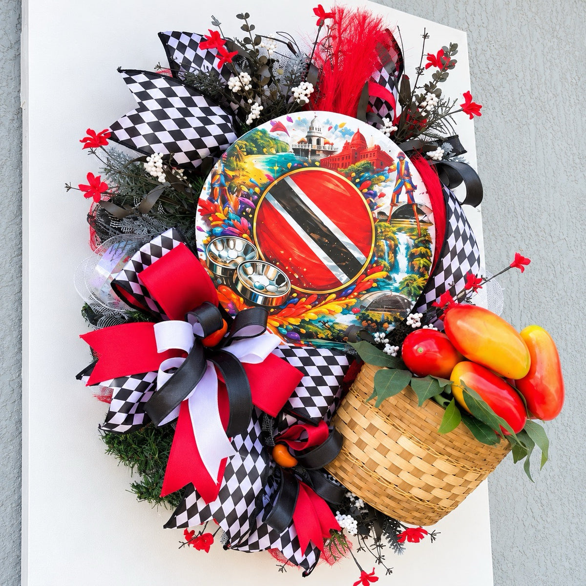 Side view of handmade Caribbean wreath showing dimensional ribbon loops, decorative greenery, centerpiece sign and woven tropical pepper basket.