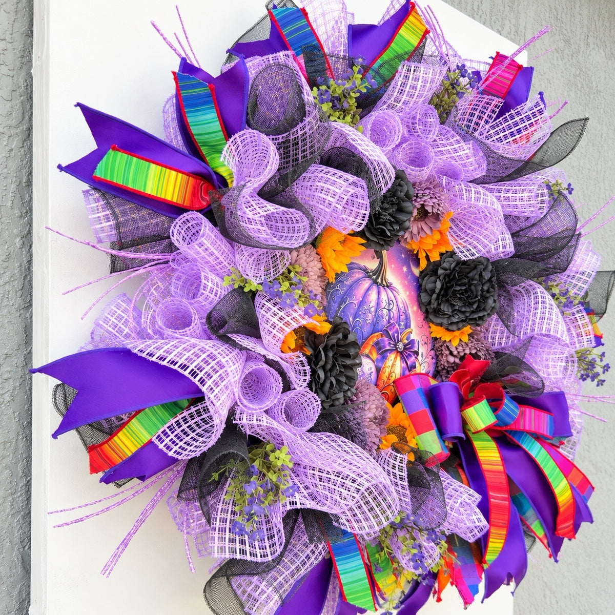 Left angle of purple Halloween wreath with layered mesh, florals and colorful wired ribbon