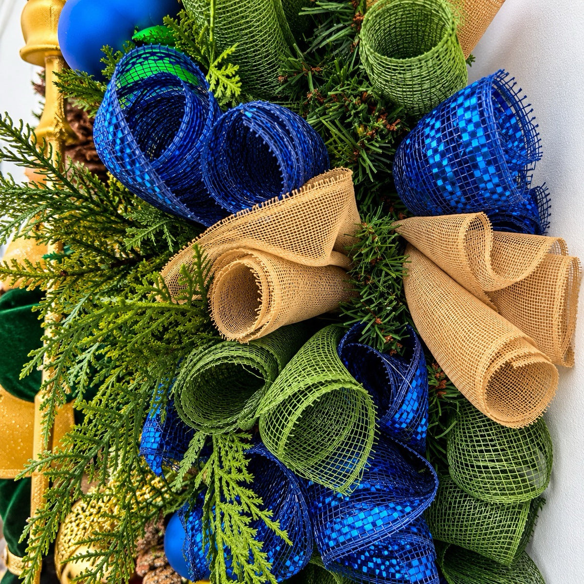 Side view showing the depth and layered greenery of the handmade Christmas wreath.