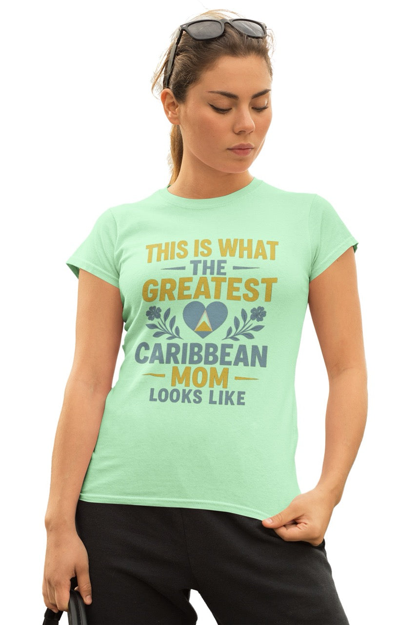 Woman wearing a green T-shirt with text reading “This is what the greatest Caribbean mom looks like,” featuring a heart with island-inspired colors and floral accents.