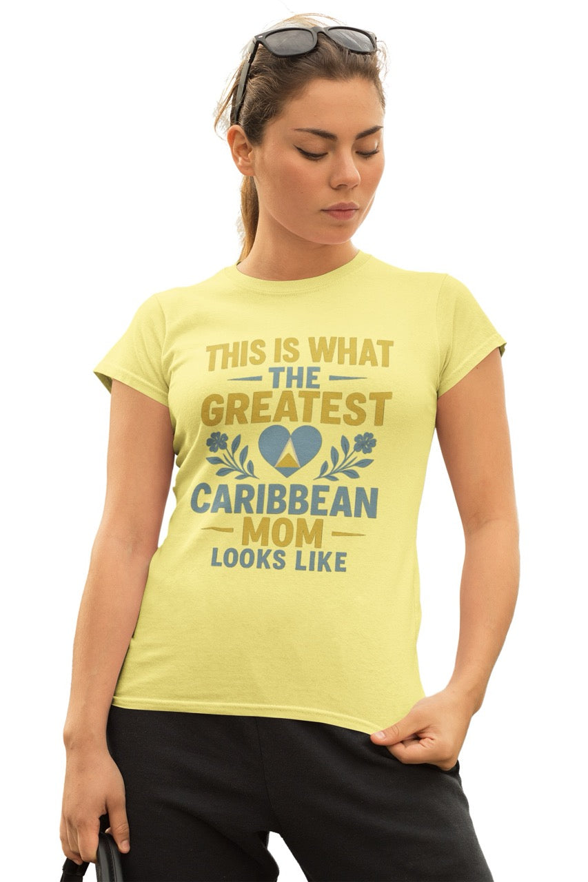 Woman wearing a yellow T-shirt with text reading “This is what the greatest Caribbean mom looks like,” featuring a heart with island-inspired colors and floral accents.