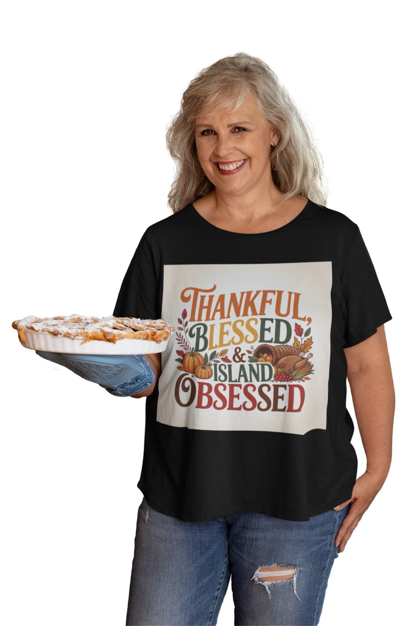 A cheerful Caribbean-inspired Thanksgiving design featuring the phrase “Thankful, Blessed & Island Obsessed.” The text is styled in bold autumn colors — orange, gold, green, and deep red — surrounded by pumpkins, colorful fall leaves, and a cornucopia overflowing with fruits and vegetables. The design beautifully blends traditional Thanksgiving symbols with tropical warmth, celebrating gratitude and island pride.