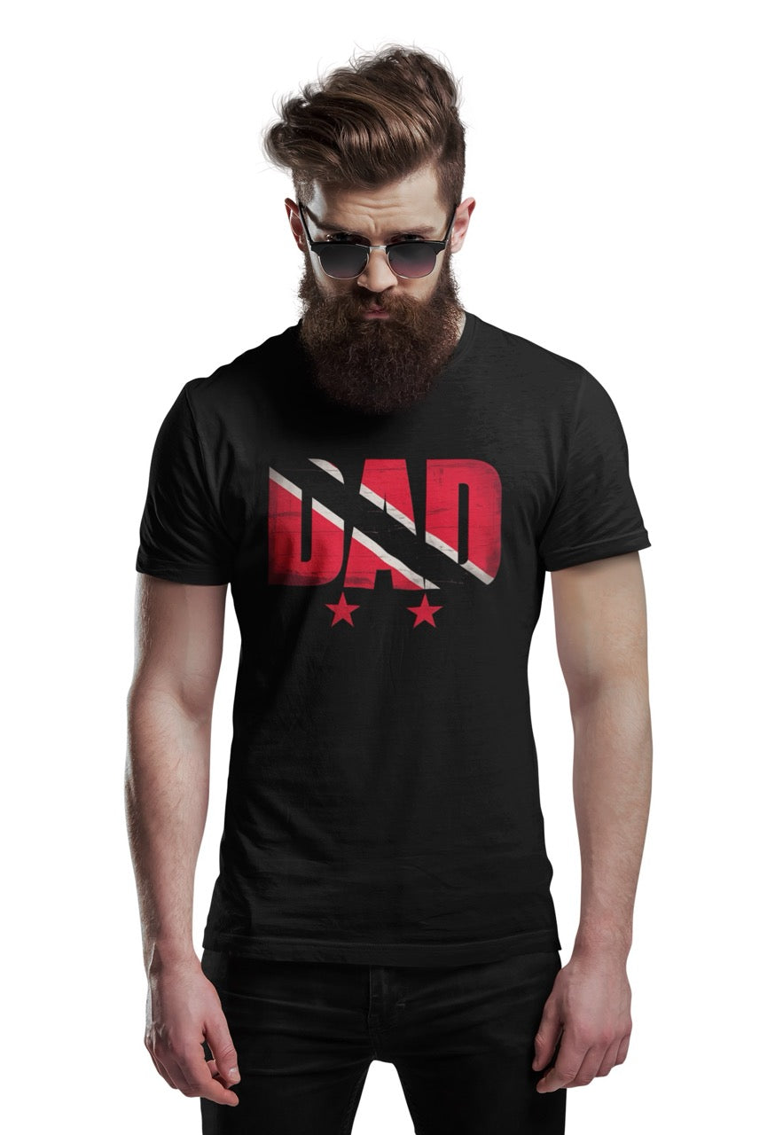 Man wearing a black T-shirt featuring bold “DAD” text filled with the Trinidad and Tobago flag colors, with three stars beneath the design.