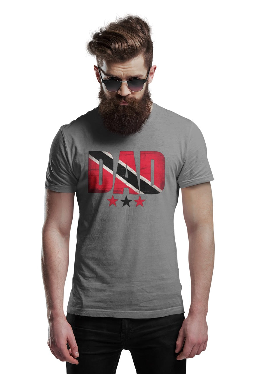 Man wearing a gray T-shirt featuring bold “DAD” text filled with the Trinidad and Tobago flag colors, with three stars beneath the design.