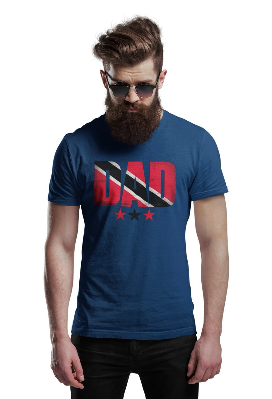 Man wearing a navy T-shirt featuring bold “DAD” text filled with the Trinidad and Tobago flag colors, with three stars beneath the design.