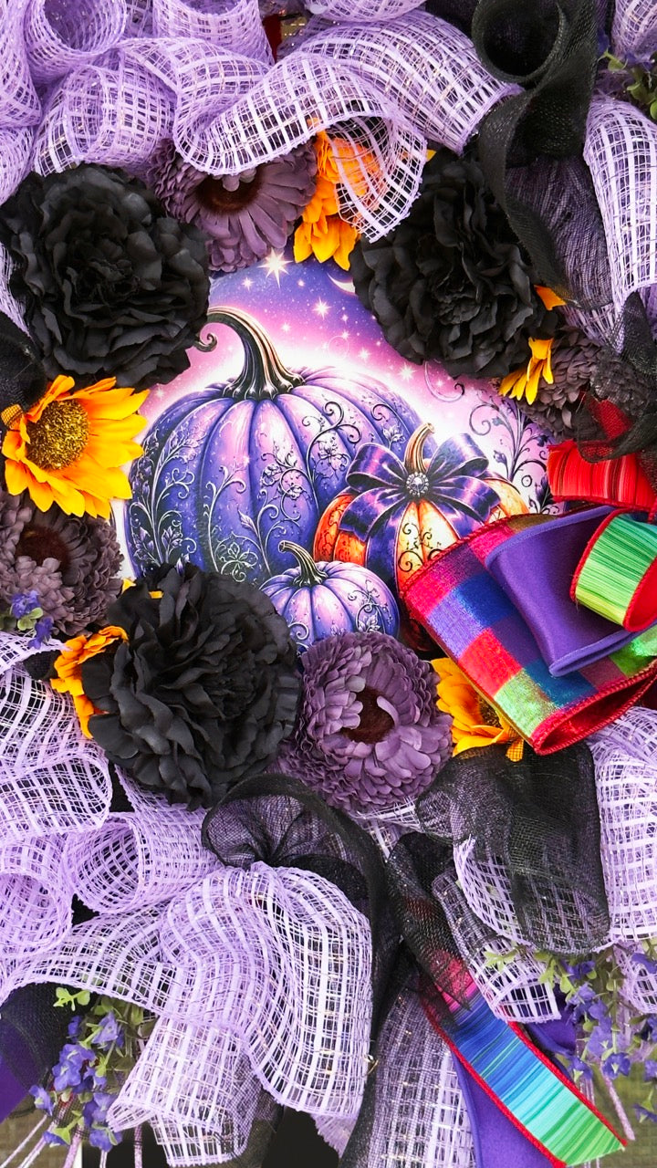Velvet Eclipse luxury handmade Halloween wreath featuring lavender deco mesh, black florals, colorful designer ribbon bow, sunflowers, and a whimsical purple pumpkin centerpiece displayed on a black front door.